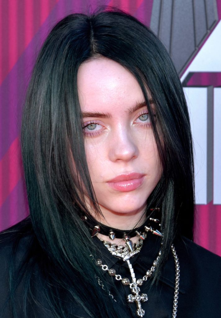 Billie Eilish, a woman with black shoulder-long hair all dressed in black.
