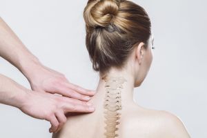 A woman from behind with an illustration of a spine on her back.