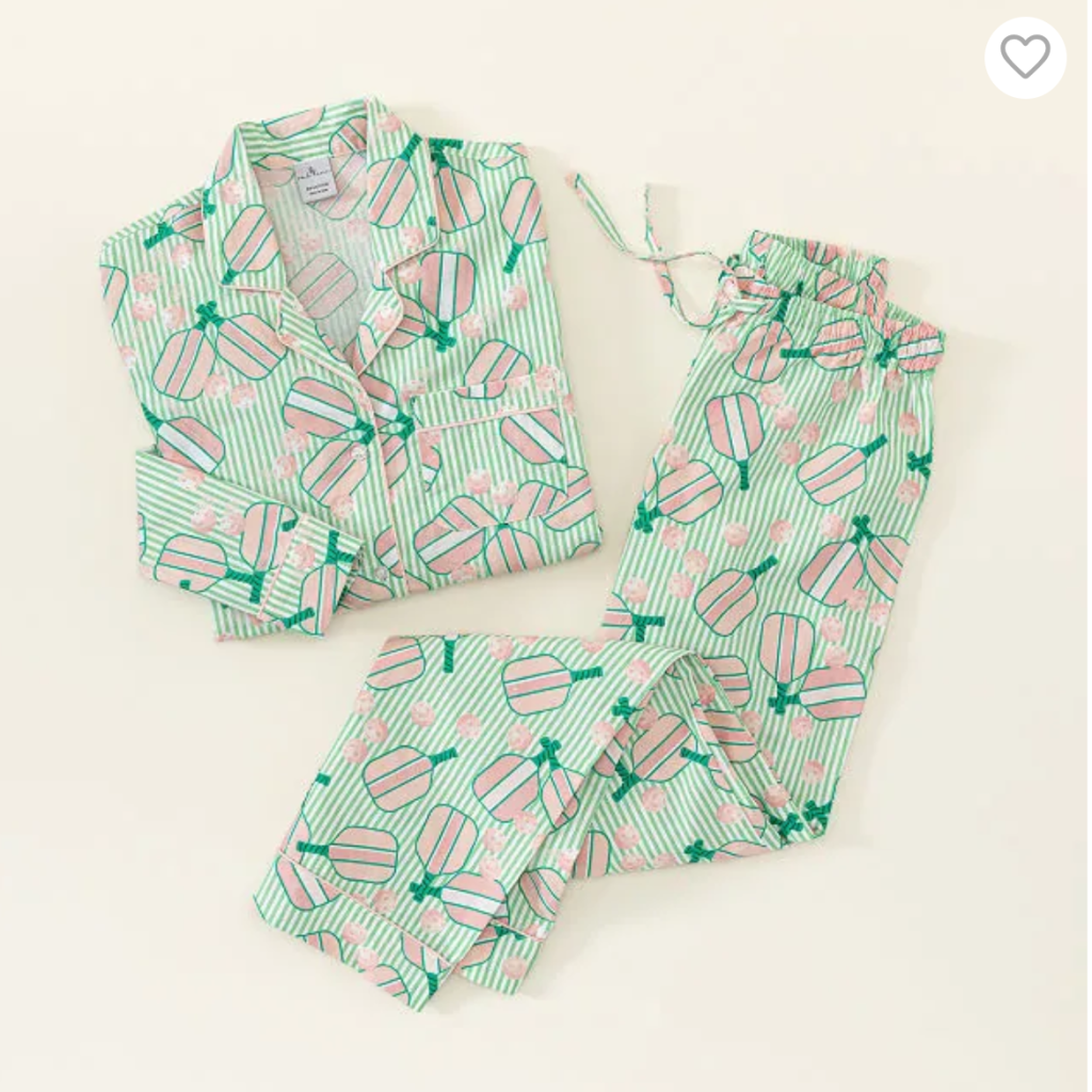 A collar pajama top and pajama pants in mint green with pink and dark green pickleball paddles and balls decorating them.