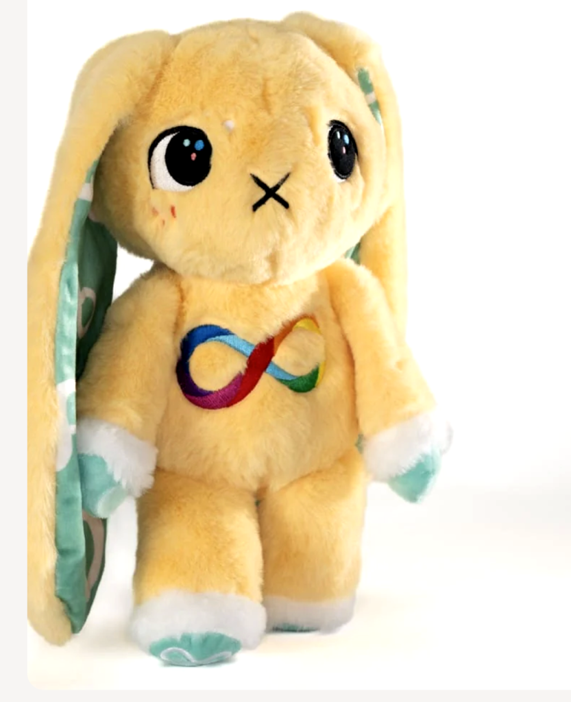 A yellow bunny with long ears and a rainbow infinity sign on its chest. Its eyes are looking off to the side. 