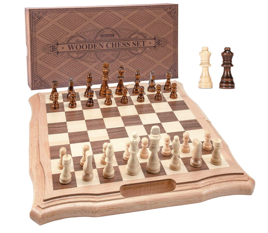 A wooden chessboard with alternating squares of light wood and dark wood with a scalloped edge. The chess pieces for each side are in place for the start of the game.