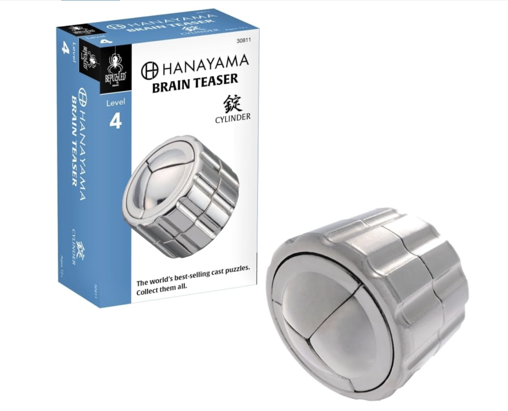 A short metal cynlinder is set on its side. There are three metal shapes inside the cylinder and a line running the distance around the cylinder. 